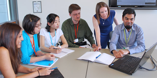 Pearl Lab team around table looking at computer