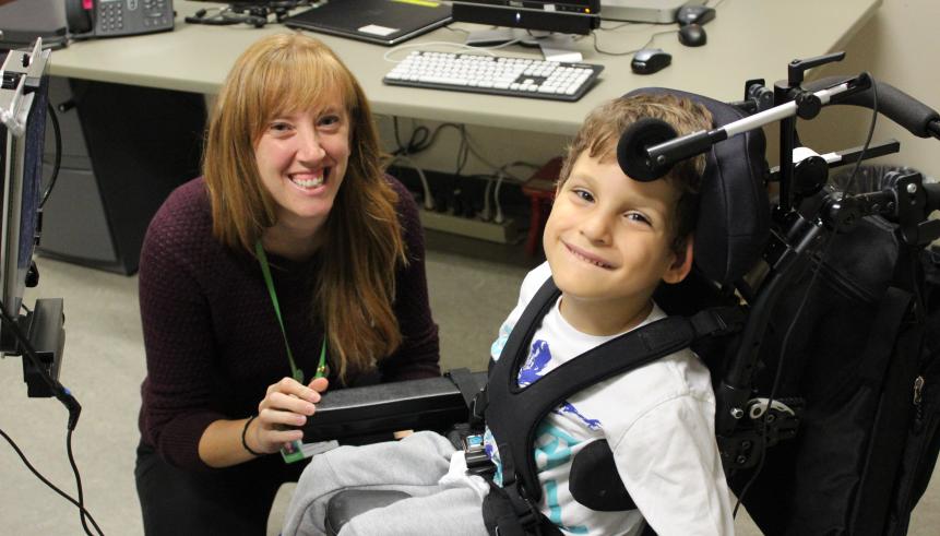 Staff with child in a wheelchair