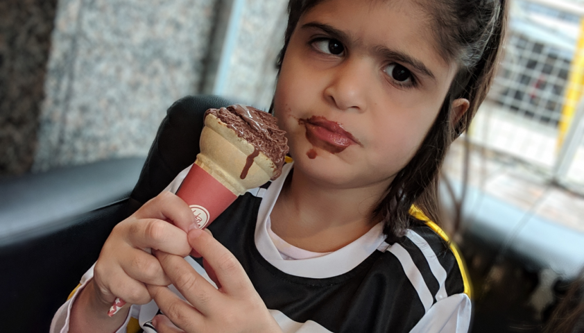 Lilly enjoying a chocolate ice cream cone 