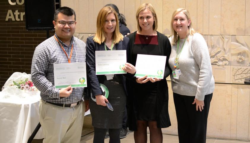 Dr. Shauna Kingsnorth, manager of Evidence to Care (far right), presents the 2019 winners of the Evidence to Care People’s Choice Poster Award. Winning team (Left to Right): Sunny Bui, Dr. Sally Lindsay, Dr. Kendall Kolne