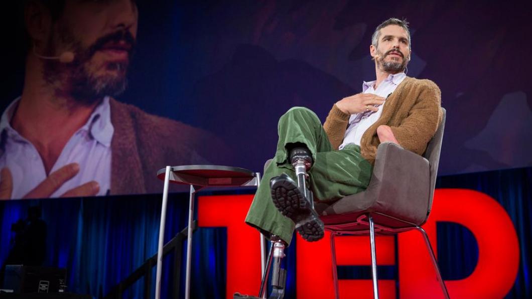 Man with amputations on stage doing Ted Talk