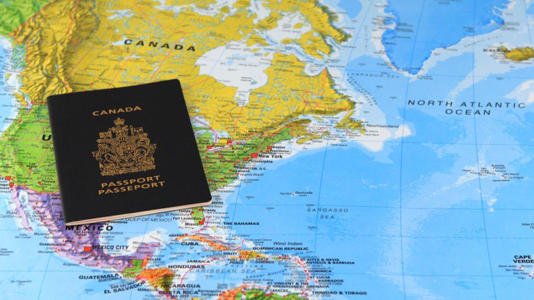 A Canadian passport on a world map