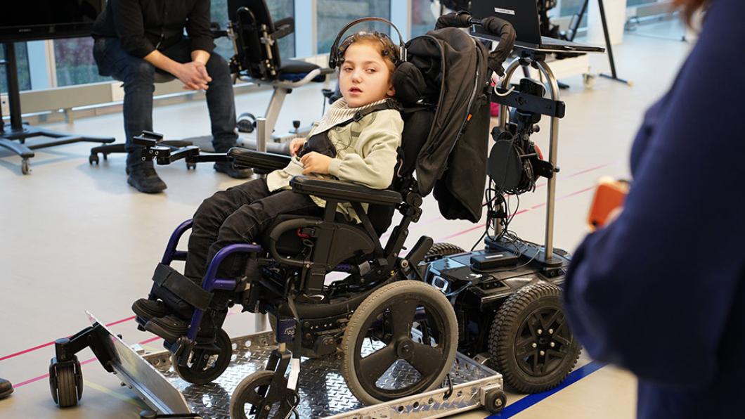 A child sitting on a computerized wheelchair