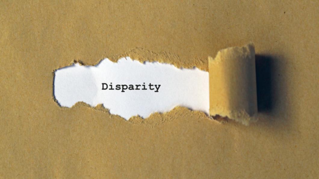 Image of brown paper being ripped back to reveal the word 'disparity'