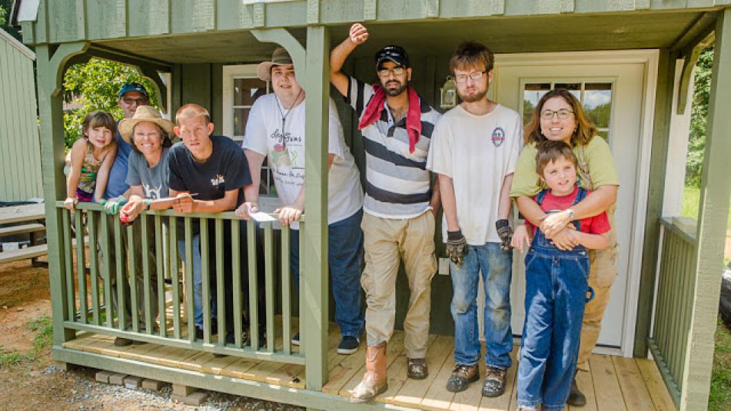 9 people standing on a porch