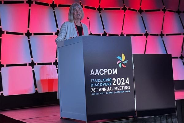 An adult standing on a stage