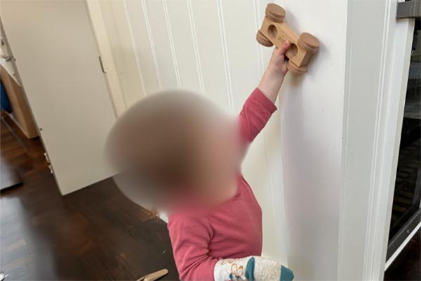 Push a toy car / ball up a wall using helper arm; hand can be fisted