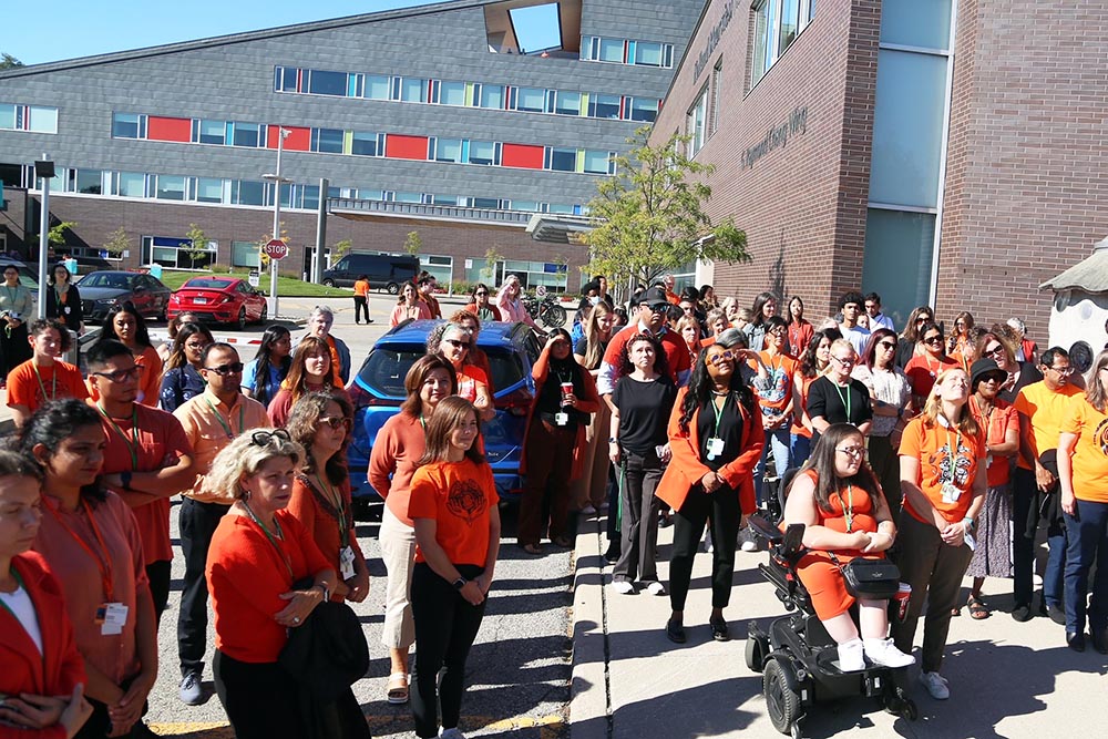 Group of people dressing in orange in a ceremony