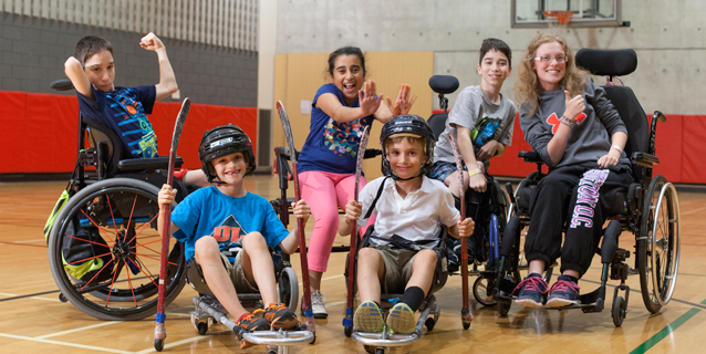 kids in wheelchairs with hockey sticks
