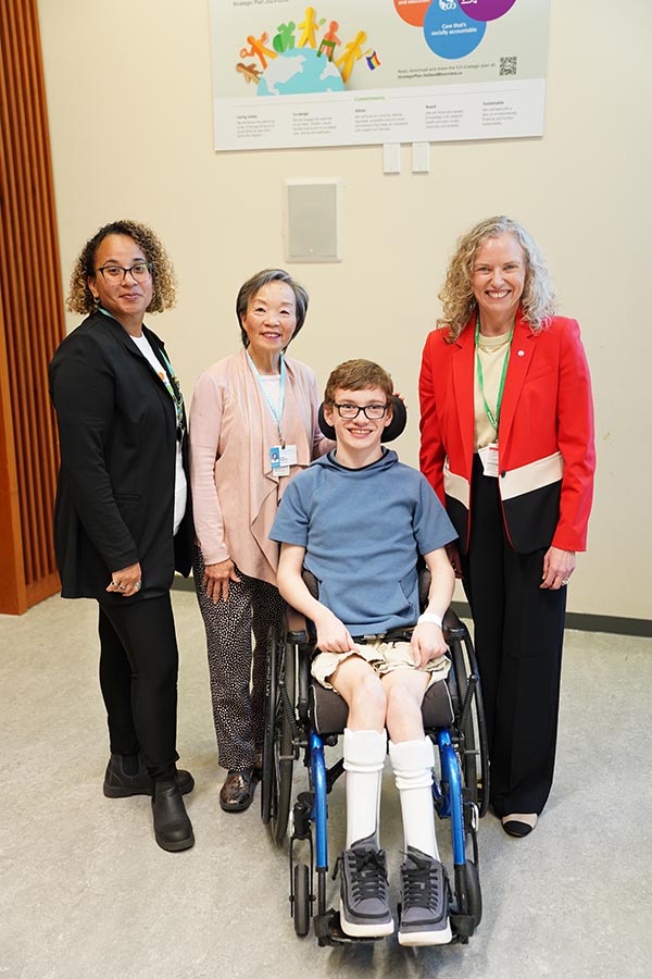Zach with Julia Hanigsberg, president and CEO (right), Helen Hayward, board director (centre) and Alifa Khan, family leader (left)