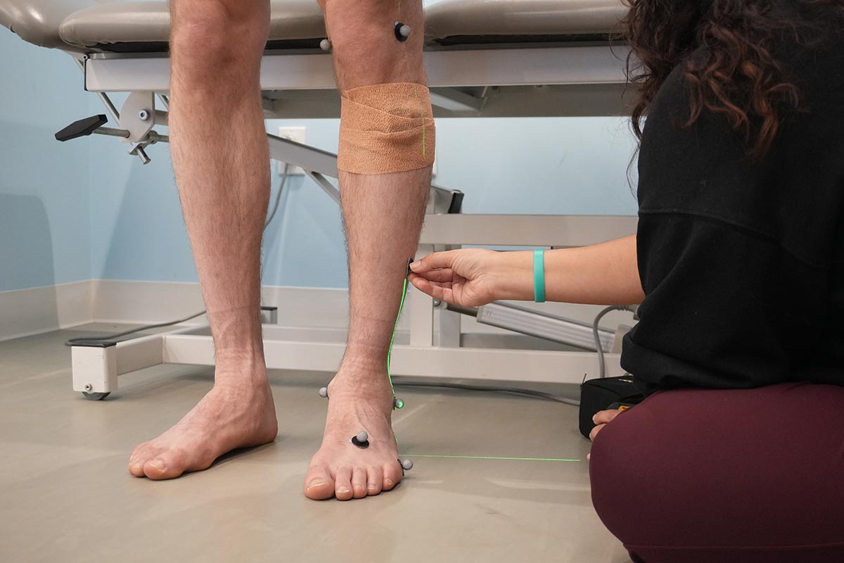 Reflective marker being placed on the leg using a laser alignment tool.