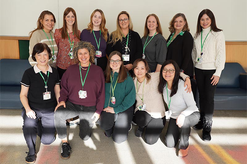 A group photo of twelve people in an indoor setting