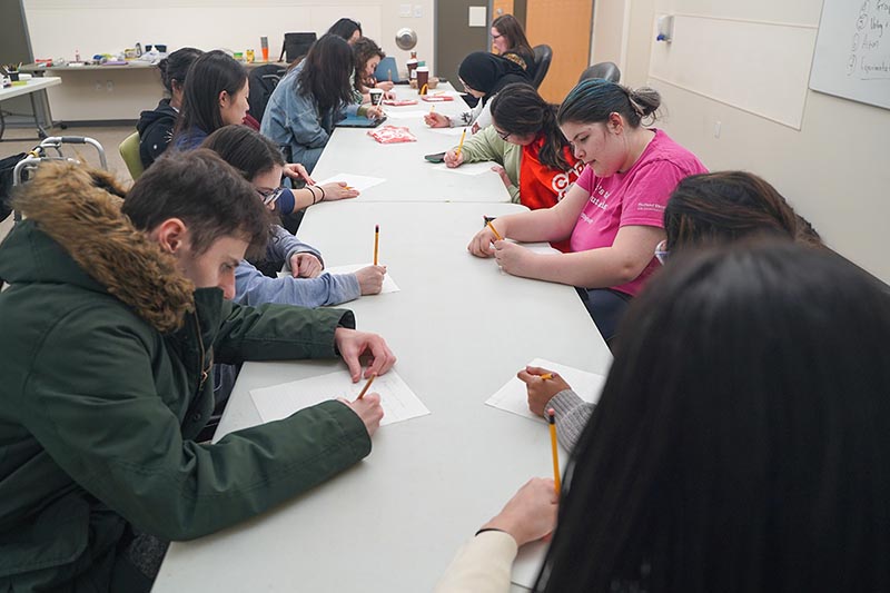 Some teens are working on some writing