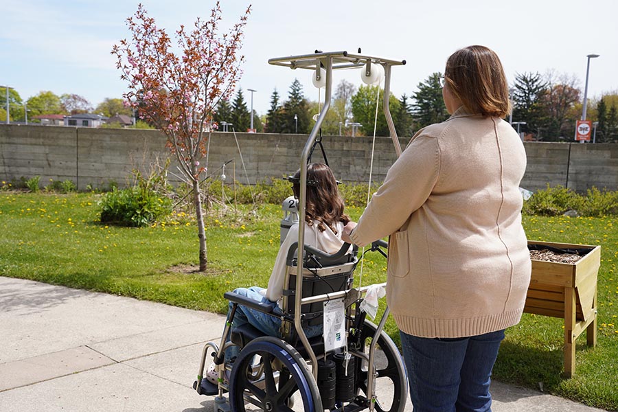 Evelyn and her mom enjoy daily outings in Holland Bloorview’s Spiral Garden  