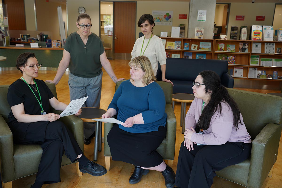 Five people in a meeting
