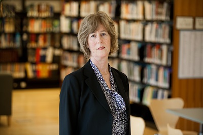 Woman with black suit in library