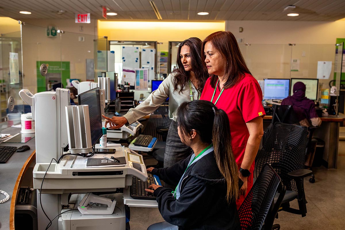 Some adults are checking information on a computer screen