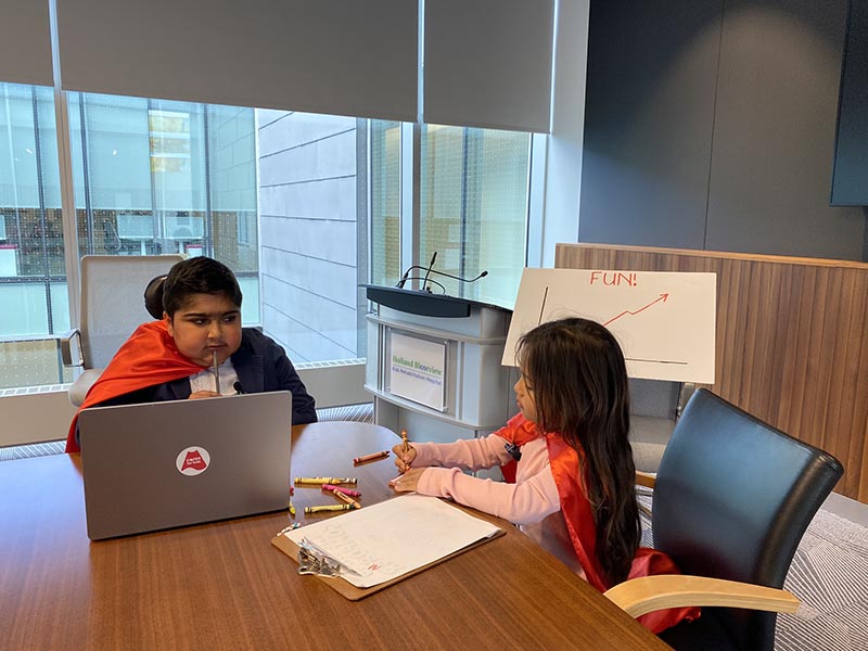 Two children pretending to have a meeting