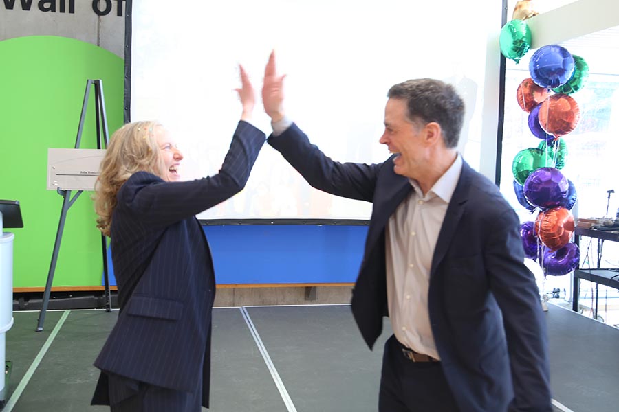 Julia Hanigsberg high fives incoming Holland Bloorview president and CEO Bruce Squires 