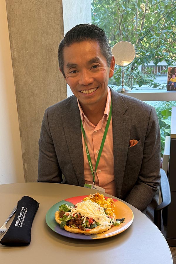 Stewart Wong, vice president, communications, strategy and sustainability, enjoying Bison Chili Bannock Taco with Winter Squash Mac & Cheese