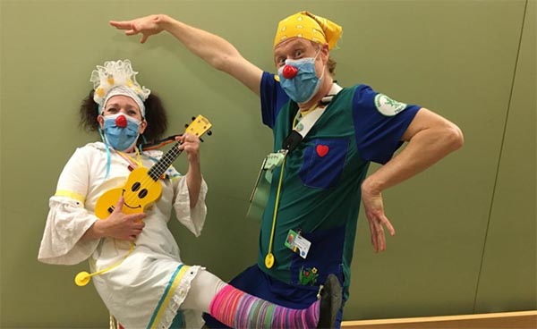 Two clowns playing music