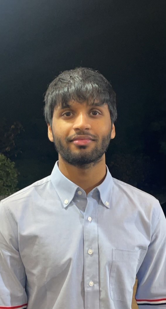 South asian man with short black hair in a grey button up