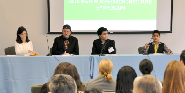 Photo of the panel at the Symposium sitting at a table.