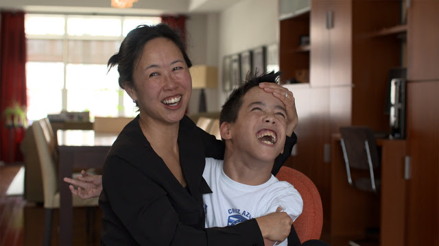 Mother and son embracing