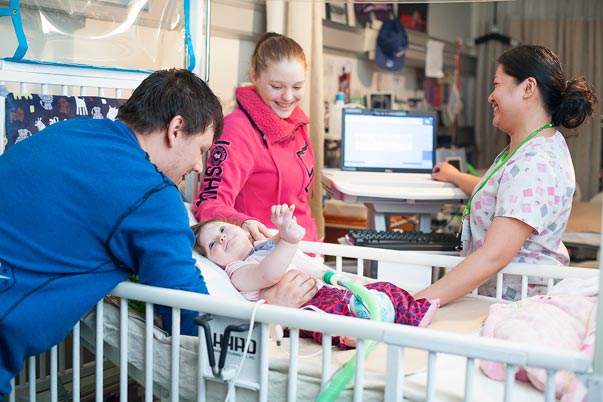 Nurse, Joy Vergara, with Zoey Faith and her parents