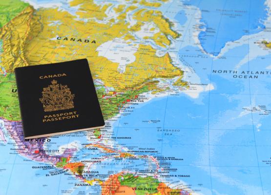 A Canadian passport on a world map