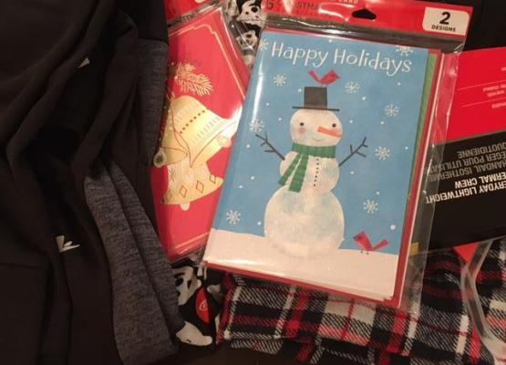 Pile of clothes with Christmas cards on top
