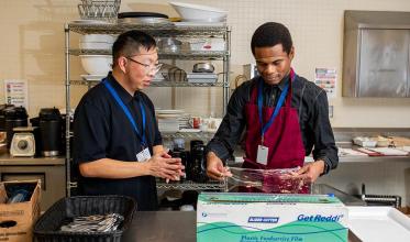 Two people working in a kitchen