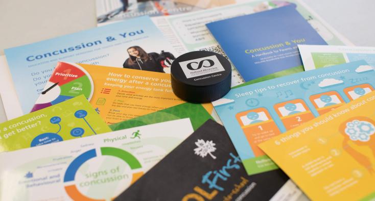 Close up of printed concussion education resources spread out on a table.