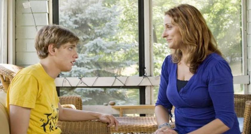 Teenager boy talking with his mother