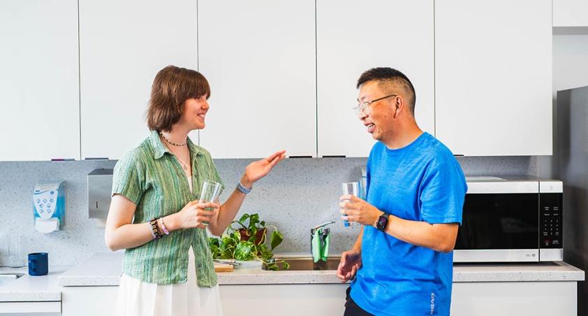 Two people talking in a pantry