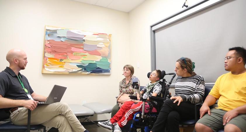 A clinician is having meeting with patient and family