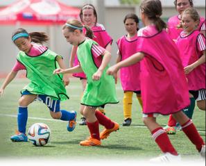 Soccer players running after the ball