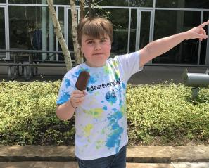 Emery in a #DearEverybody shirt with a popsicle