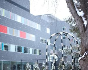 A wintery scene in Spiral Garden with the Holland Bloorview building in the background 