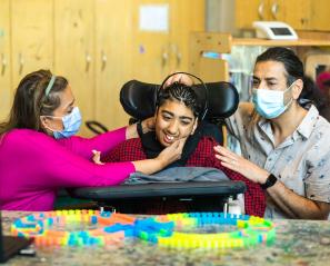 Hospital staffs setting up a headset machine on a child's head