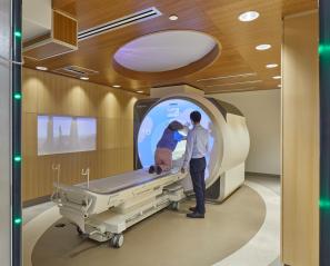 Child entering MRI Machine and doctor standing beside them 