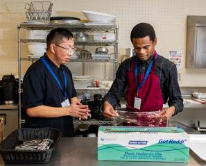 Two people working in a kitchen