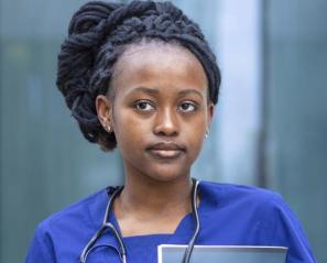 Woman with hair in braids wearing scrubs