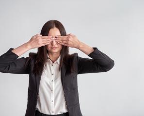 Woman puts hands over eyes