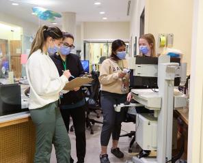 Some hospital staffs working in front of a station