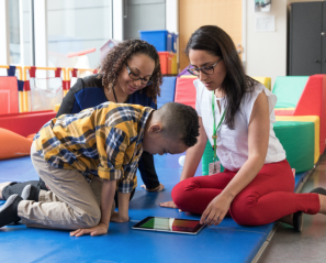 Two adults playing with a kid