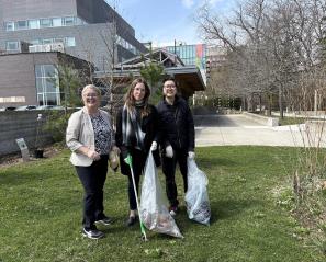 Some people picking up garbage from the glass.