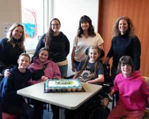 Holland Bloorview mothers Jenny, Jessica, Melissa and Allyson stand behind their daughters and inpatient clients Hannah, XX, Finnley and Scarlett who met during their time at the hospital. 