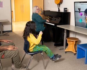 A child plays music using a virtual music instrument