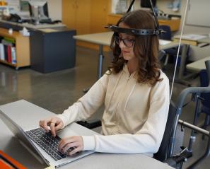 Teen sitting at a desk with her laptop open